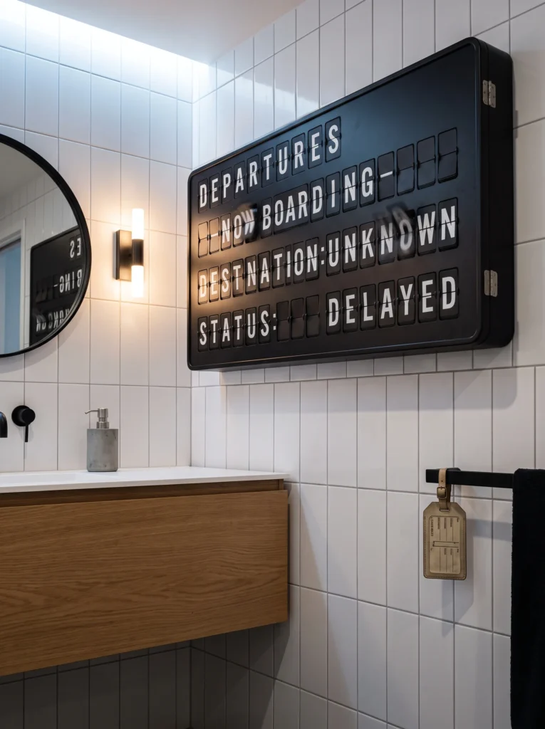  Black split flap airport departures board on white tile reading departures now boarding, destination unknown, status delayed
