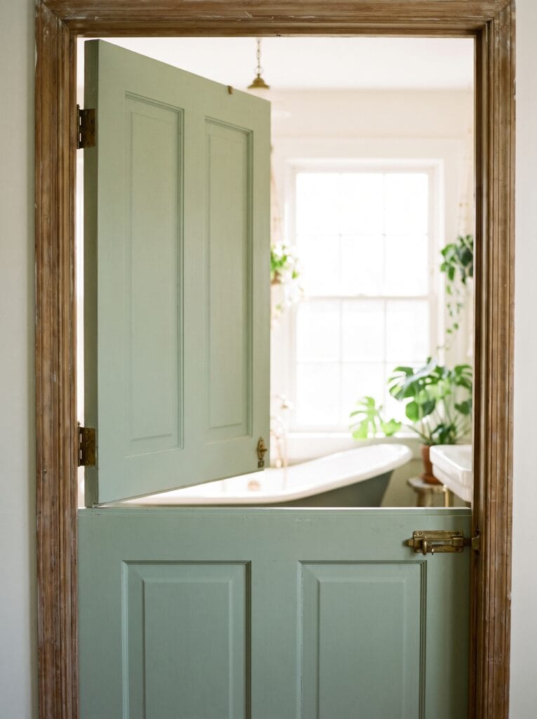 Sage green dutch door split horizontally with the top half open