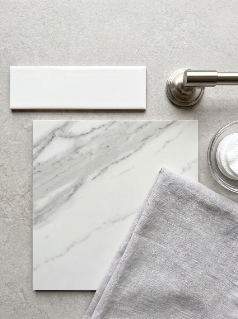 bathroom samples: white subway tile, marble-look tile and brushed nickel towel bar