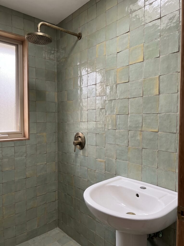 Green tile bathroom ideas in warm sage zellige for a north-facing shower