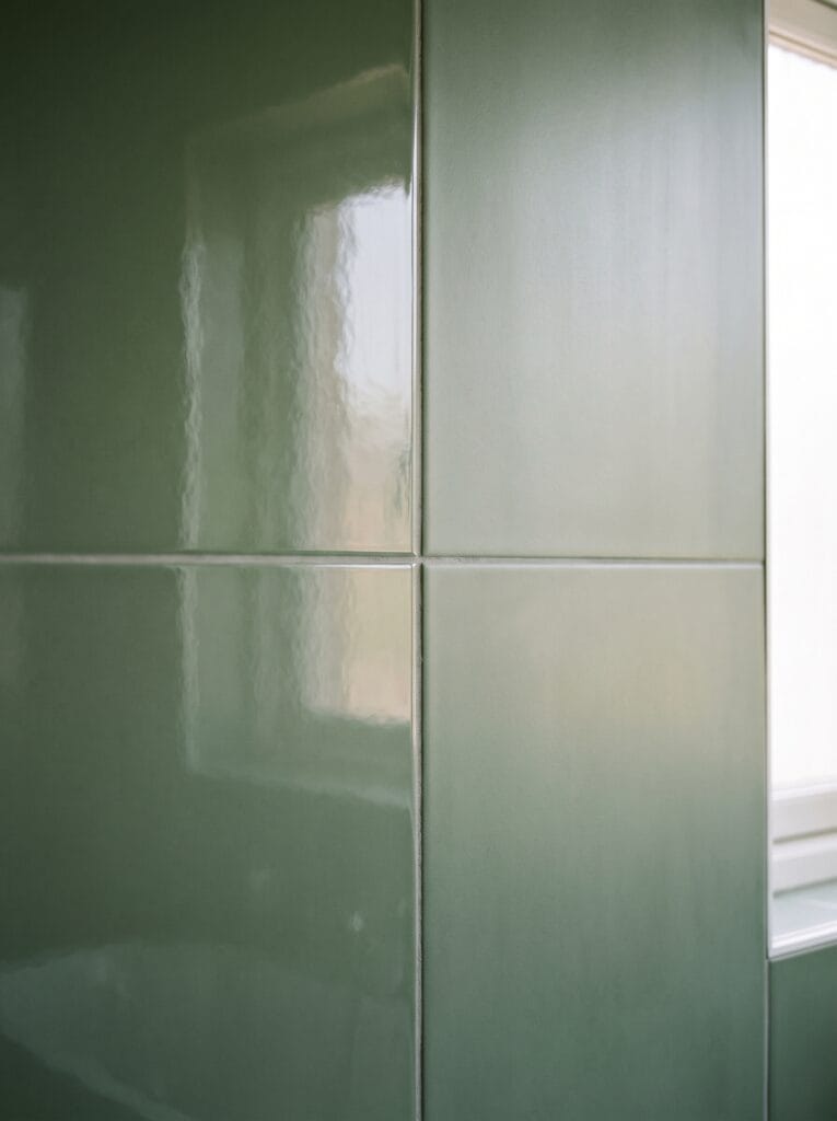 Same green tile in glossy and matte finish side by side on one wall